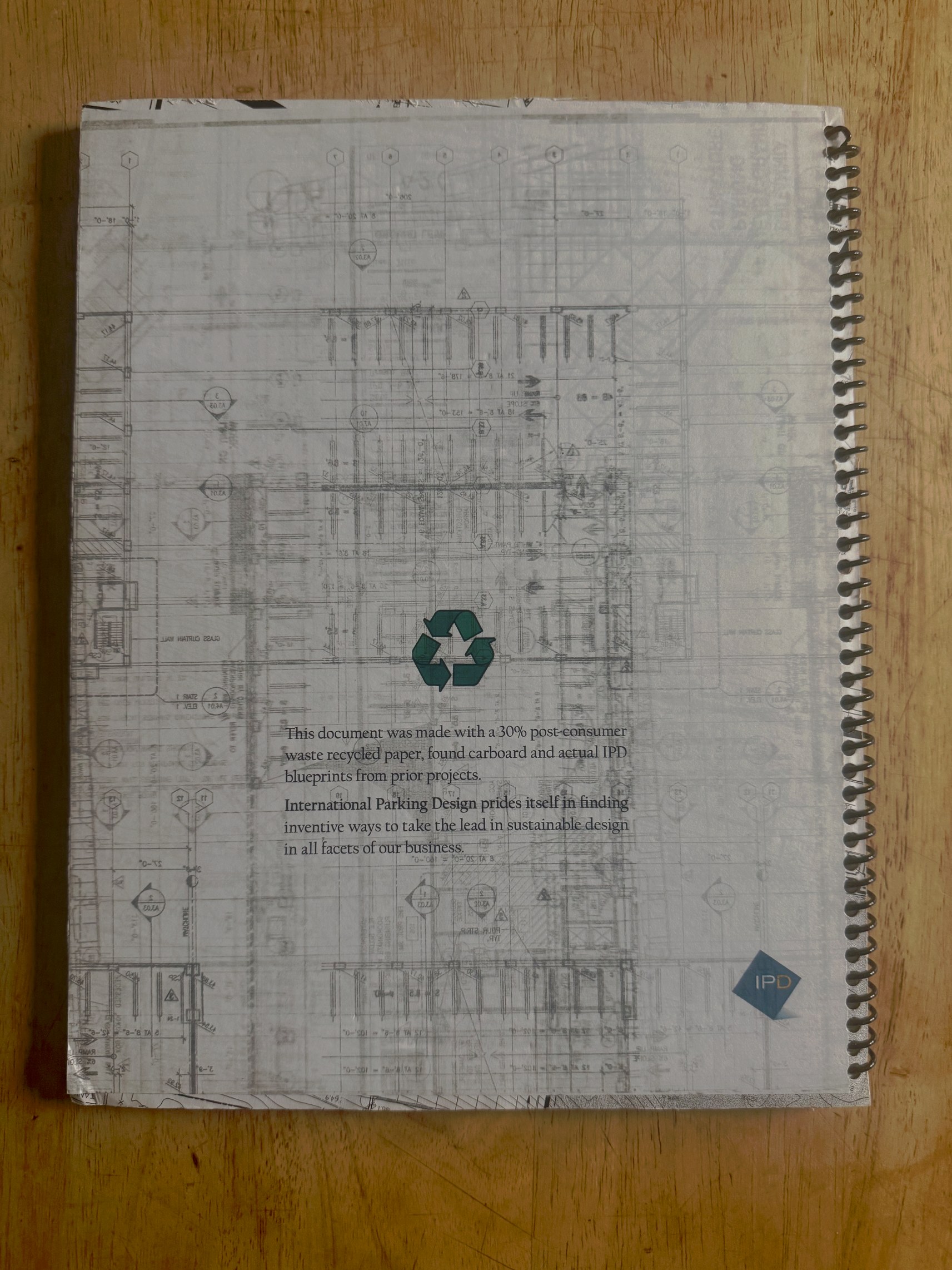 IPD Santa Monica proposal back cover — blueprint drawings, recycling symbol, and colophon statement about sustainable materials