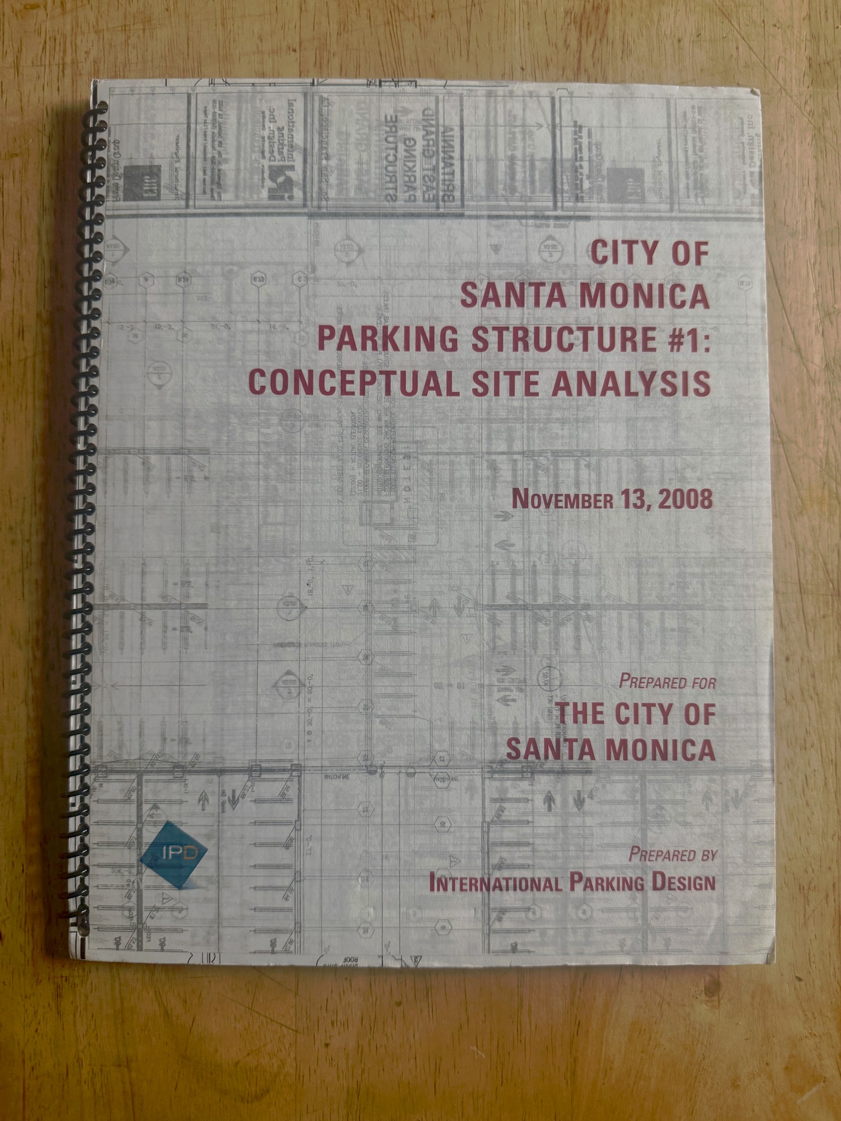 IPD proposal cover for the City of Santa Monica 4th Street Parking Structure, with discarded architectural blueprints ghosted behind the title